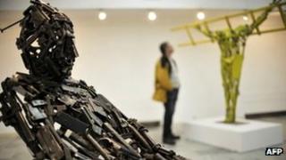 A sculpture made of parts from old weapons is presented at the Kosovo Gallery of Arts during an exhibition by Albanian artist Ismet Jonuzi in Pristina, 21 February