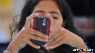 A woman uses her Blackberry smartphone