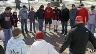 A group of students pray for the victims of a high school shooting in Chardon, Ohio 28 February 2012