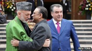 Tajikistan's President Imomali Rakhmon watches as President Karzai of Afghanistan embraces Pakistan's President Zardari (March 20102)