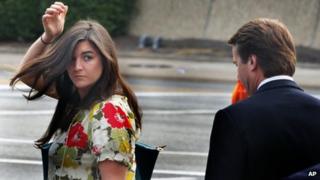 Cate Edwards looks back at her father, John Edwards, as they leave court in Greensboro, North Carolina, on 2 May 2012