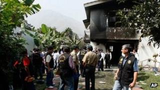 Police officers at the site of the fire at the Sacred Heart of Jesus clinic in Chosica, Peru.