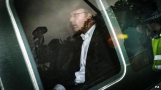 Andy Coulson arrives at a police station