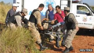An injured policeman is taken from the scene of the clashes