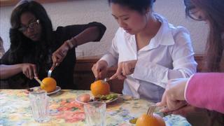 Peeling orange with a knife and fork