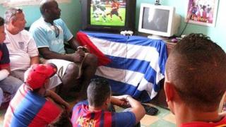 Cubans watch a football game