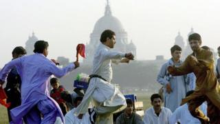 Afghans dancing in front of the Victoria memorial in India.
