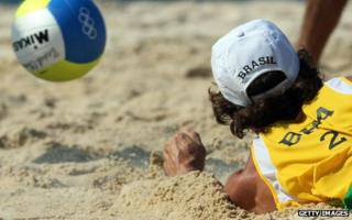 Brazilian player dives for the ball in beach volleyball tournament at Beijing Olympics, 2008