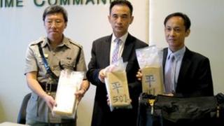 Hong Kong customs officials show the cocaine seized on 4 July to the media, 6 July 2012