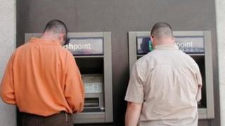 Customers use cash machines