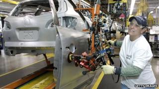 A worker builds an SUV at a General Motors plant in Lansing, Michigan