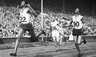 Arthur Wint equals the world record as he wins Olympic gold in the 400 metres event at Wembley Stadium in London, August 1948. Fellow Jamaican Herbert McKenley, right, finished second
