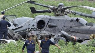 Indian Air Force personnel salvage the remains after two air force helicopters collide and crash in Gujarat on 30 August 2012
