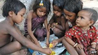 Children eating in a slum dwelling in India