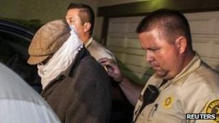 Nakoula Basseley Nakoula with hat, scarf and glasses on being escorted from his home