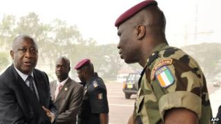 Former President Laurent Gbagbo (L) shaking hands with General Dogbo Ble (R) - file photo