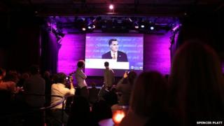 People watch the debate at a venue hall