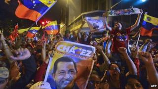 Supporters of Venezuelan President Hugo Chavez celebrate after receiving news of his re-election in Caracas (7 Oct)