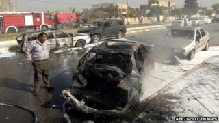 A man looks at destroyed vehicles after two car bombs exploded near the provincial government headquarters in Kirkuk, northern Iraq, on 15 October 2012.
