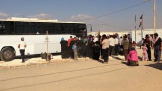 A bus prepares to leave the Zaatari Refugee Camp