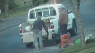 Oliver and another worker loading rubble into a truck