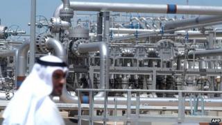 A worker walks at Gathering Centre 15 (GC 15) oil facility in the northern al-Rawdhatain oilfield, Kuwait (2005)
