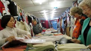 A Vietnamese immigrant sells clothes in a shop in Warsaw