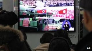 People in Seoul watch TV news showing file footage of a North Korean rocket carried during a military parade. Photo: 24 January 2013