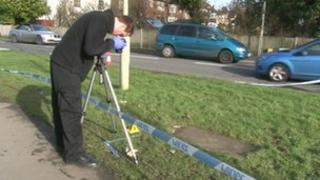 Forensic teams examine the scene near the University campus
