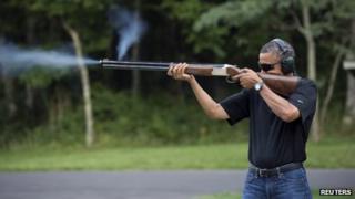 President Barack Obama shoots clay targets on the range at Camp David, Maryland, in this White House handout photo taken 4 August 2012