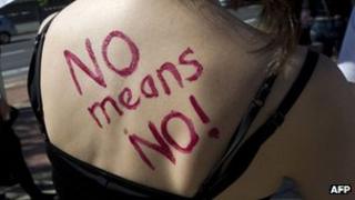 "No means no" written on the back of woman during a protest in South Africa