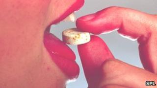 Woman taking a zinc tablet