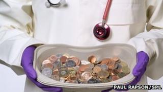 doctor holding a tray of money