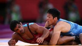 India's Sushil Kumar (L) wrestles Japan"s Tatsuhiro Yonemitsu in their Men's 66kg Freestyle gold medal match on August 12, 2012 during the wrestling event of the London 2012 Olympic Games