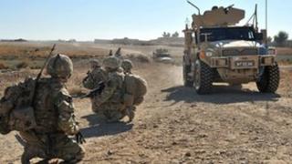 Husky protected support vehicle passing unidentified British soldiers