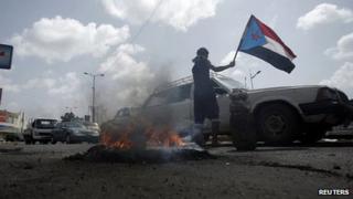 Follower of separatist Southern Movement holds a flag of former South Yemen in Aden. 26 Feb 2013