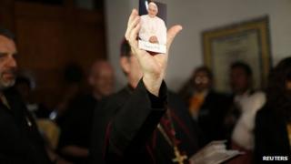 Apostolic Nuncio to Mexico Christopher Pierre shows a portrait of Pope Benedict XVI during a farewell event organized by catholic worshipers in Mexico City
