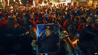 Supporters of Venezuelan President Hugo Chavez shout slogans outside the Military Hospital in Caracas on Tuesday evening after hearing of their leader's death