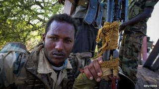 A soldier of the Somali National Army (SNA) rests on a bridge 7km (4 miles) east of the central Somali town of Buur-Hakba