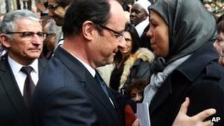 French President Francois Hollande, left, hugs Latifa Ibn Ziaten, mother of French soldier Imad ibn Ziaten, in Toulouse, March 17, 2013