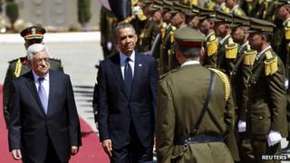 Barack Obama and Palestinian President Mahmoud Abbas (L) stand together in the West Bank