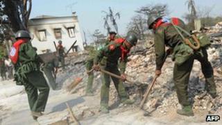 Soldiers take part in clean-up operations after an outbreak of deadly communal violence claimed in Meiktila, central Burma, on 24 March 2013