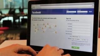 Man using Facebook on a laptop