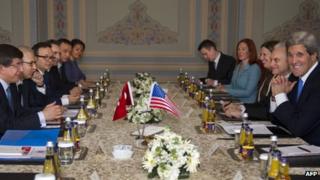 US Secretary of State John Kerry (right, foreground) faces Turkish Foreign Minister Ahmet Davutoglu (opposite) at talks in Istanbul, 7 April