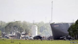Workers are seen at the site of a fertilizer plant a day after a massive explosion in the town of West, near Waco
