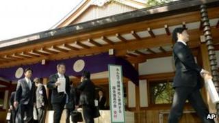 A group of Japanese lawmakers leave after they offered prayers at the Yasukuni Shrine in Tokyo during an annual spring festival on 23 April 2013