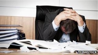 Man despairing at a desk