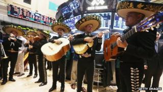 The band Mariachi Real de Mexico waits to perform on the floor of the New York Stock Exchange ahead of the Cinco de Mayo holiday