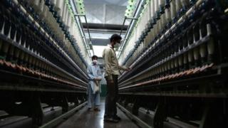 Pakistani workers carry out their daily work at the Kohinoor textiles factory in Rawalpind