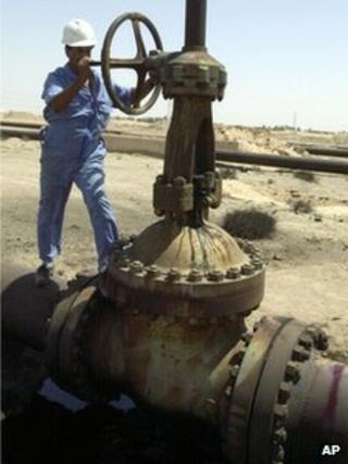 Oil worker near pipeline in Basra, Iraq, in 2004